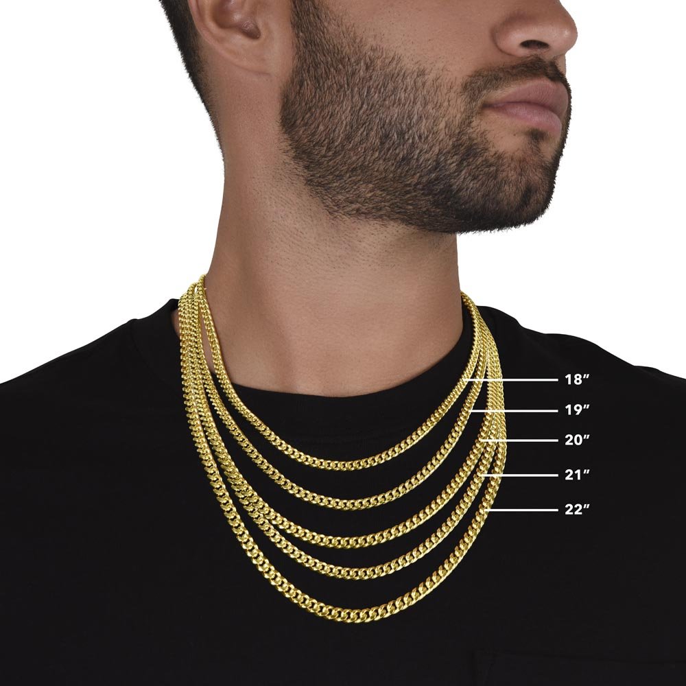 A close look at a man wearing and showing a different-length yellow gold finish necklace 