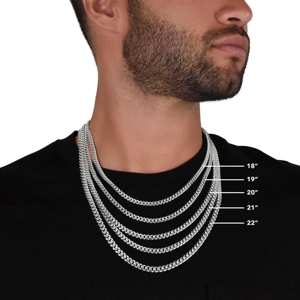 A close look at a man wearing and showing a different-length white gold finish necklace 