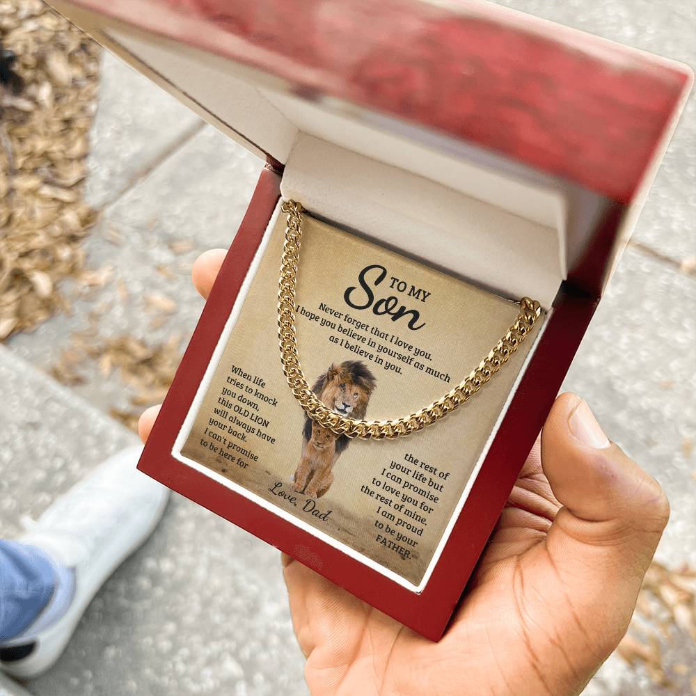 A man hand holding a luxury gift box with Encouraging message for a son with a lion image and necklace.