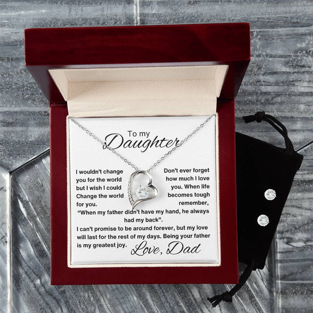 A luxury gift box containing a necklace with a heart pendant. The necklace comes with a card that reads, "To My Daughter: I wouldn't change you for the world, but I wish I could change the world for you. Love, Dad."in grey background