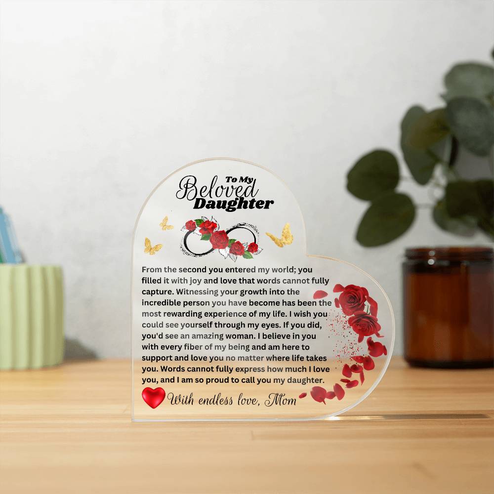 Heart shaped Acrylic plaque printed with a heartfelt message to my daughter from Mom. a gift for daughter. on a table