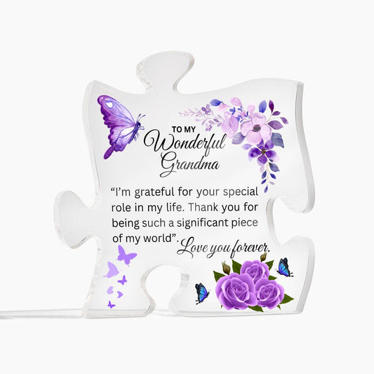 Acrylic puzzle piece plaque for grandma with a heartfelt message, adorned with purple flowers and butterflies.