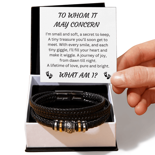 Black leather bracelet in a gift box with a card featuring a riddle, and baby footprints. A pregnancy announcement gift.