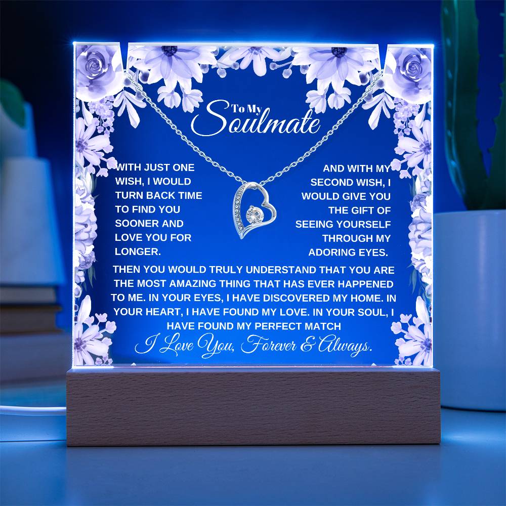 A lit wooden display case acrylic plaque with a white gold heart-shaped pendant lighted up in blue The text inside reads, "To My Soulmate" it'a a custom soulmate gift for christmas or birthday