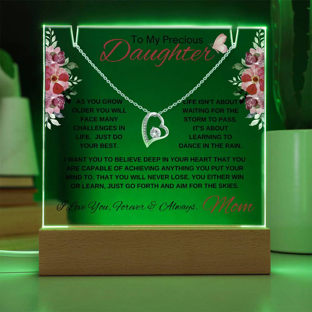 Illuminated acrylic plaque with inspirational message for a daughter and a white gold heart necklace.