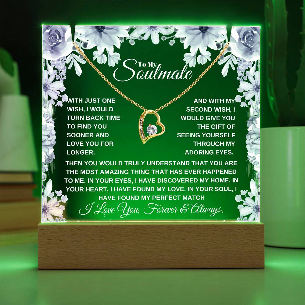 A lit wooden display case acrylic plaque with a gold heart-shaped pendant lighted up in green The text inside reads, "To My Soulmate" it'a a custom soulmate gift for christmas or birthday