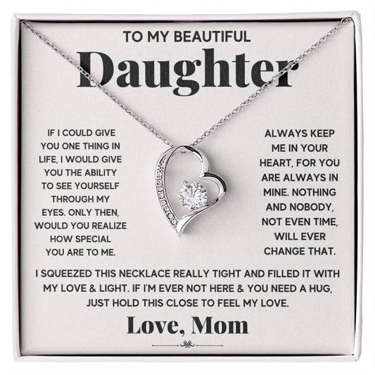 A silver heart necklace gift set with a loving message from a mother to her daughter.