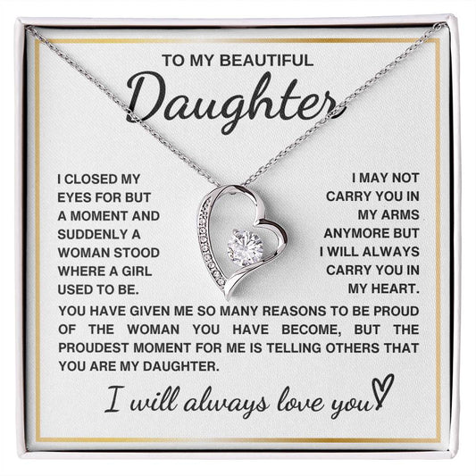 Heart-shaped necklace with a message to a daughter expressing love and pride.